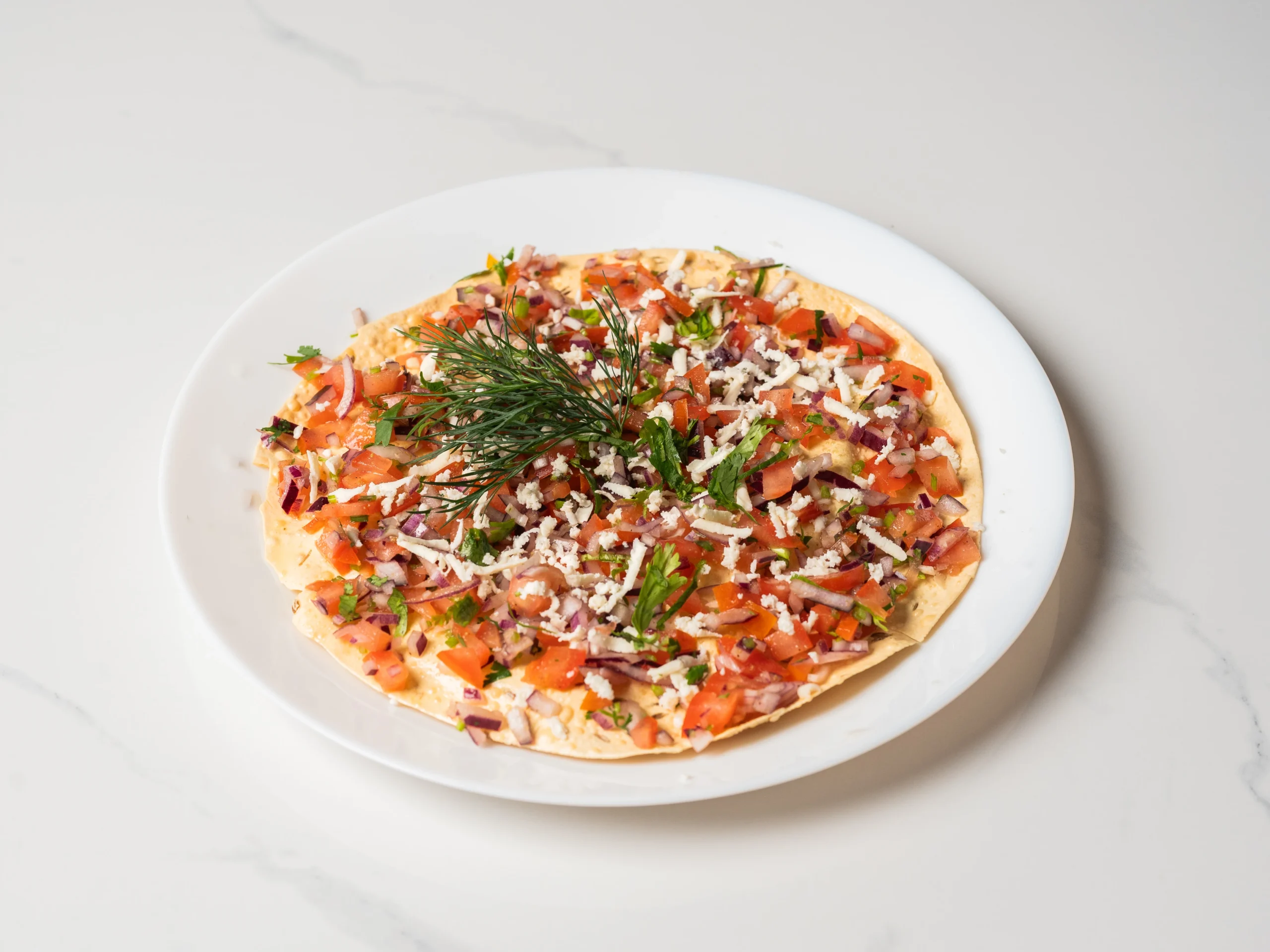 Masala papad topped with onions tomatoes and spices Indian starter in Den Haag Masala papad topped with onions tomatoes and spices Indian starter in Den Haag