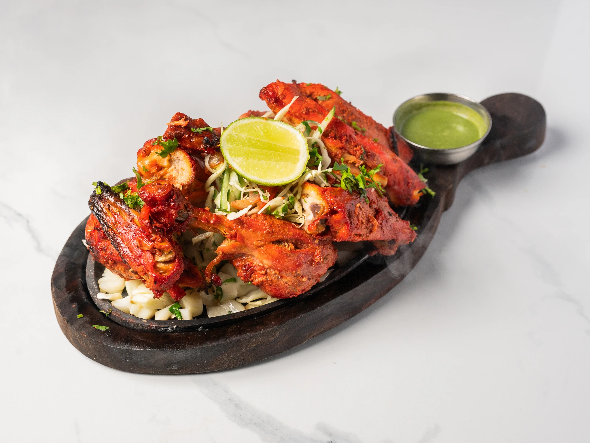 TANDOORI CHICKEN marinated chicken on bone roasted in clay oven Indian tandoori dish in Den Haag TANDOORI CHICKEN marinated chicken on bone roasted in clay oven Indian tandoori dish in Den Haag