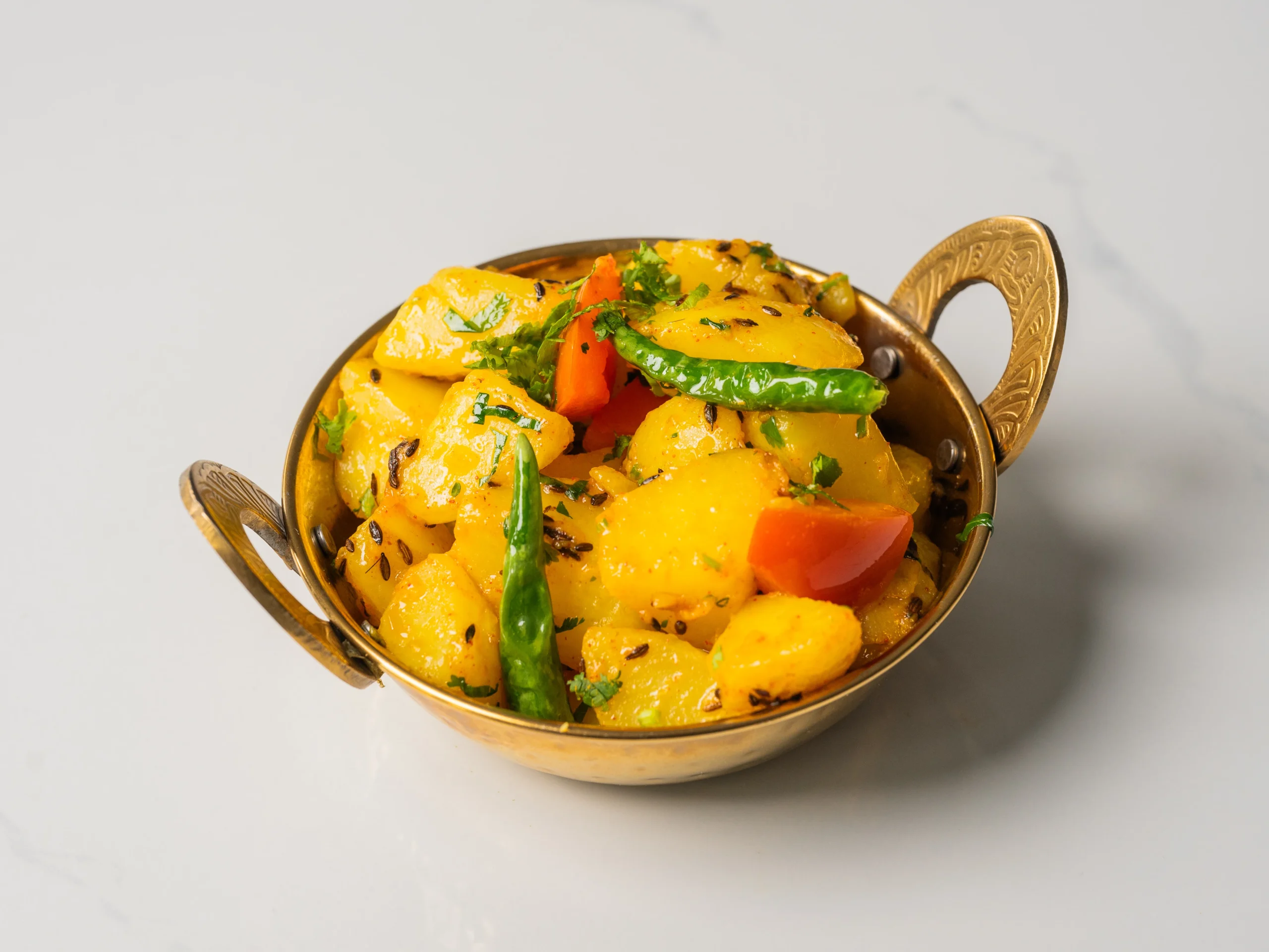 ALOO JEERA cumin spiced potato curry Indian vegetarian dish served with naan in Den Haag ALOO JEERA cumin spiced potato curry Indian vegetarian dish served with naan in Den Haag